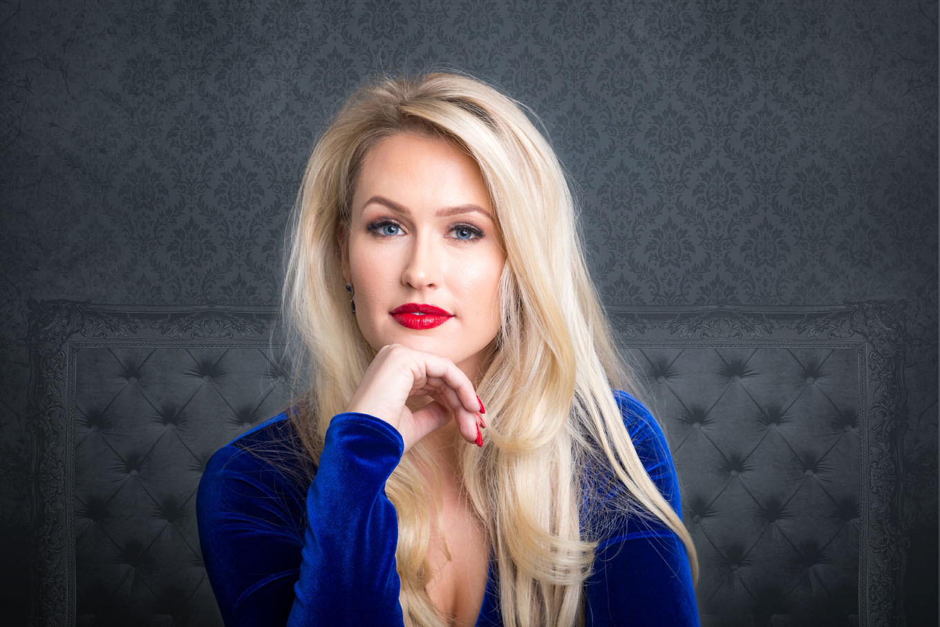 A portrait of a woman taken in a studio set up with backdrop and lighting equipment